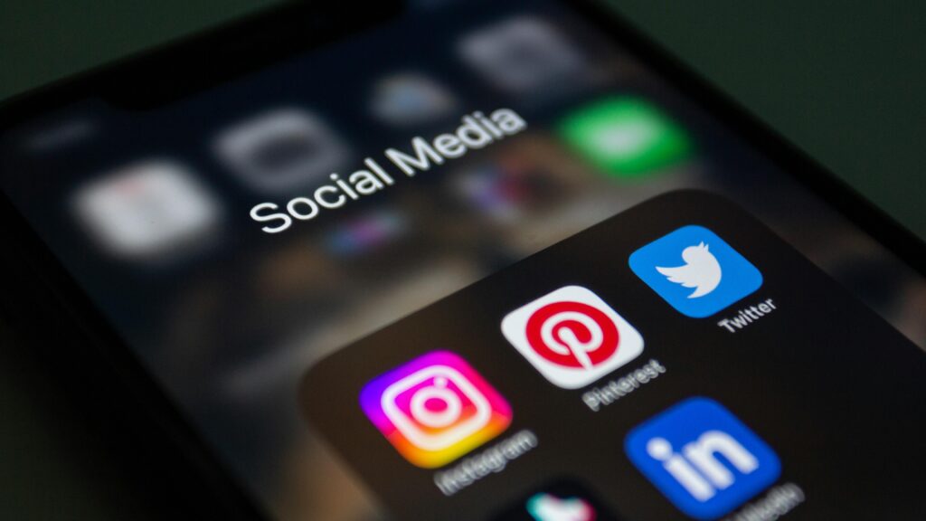 How Social Media Marketing Increases Brand Awareness A smartphone screen displaying popular social media applications like Instagram and Twitter.